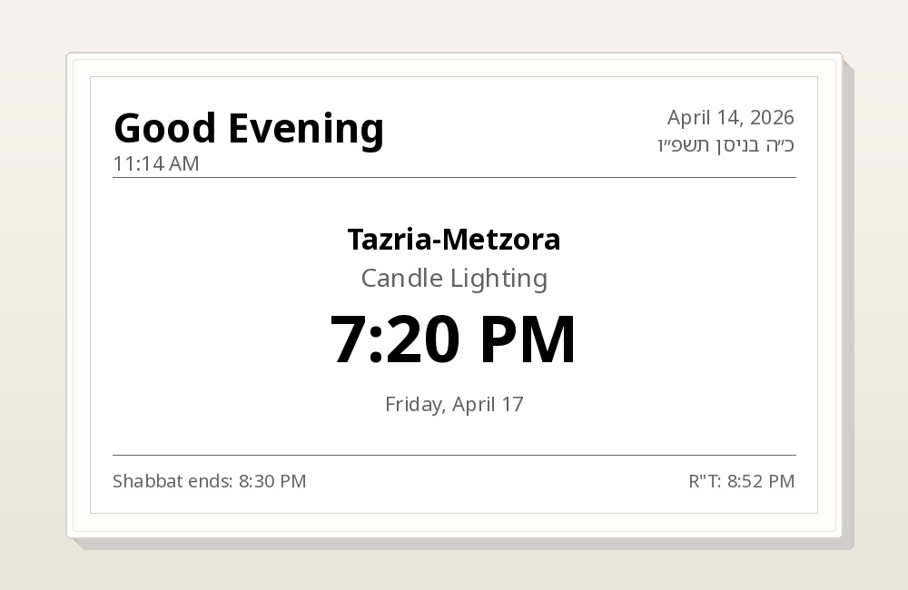 Is It Shabbos Yet e-ink display showing Shabbat times on a marble countertop next to silver candlesticks